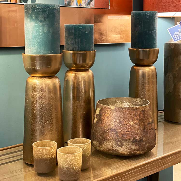 Luxury green cylinder candles in aged bronze tall holders