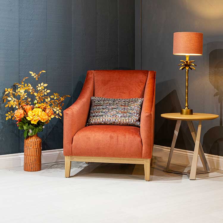 Mylands dark blue paint contrasts nicely with this orange armchair