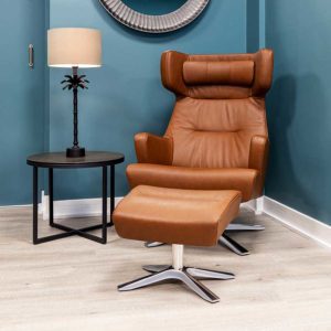 Myplace swivel recliner armchair with matching footstool upholstered in rich camel leather with chrome stand
