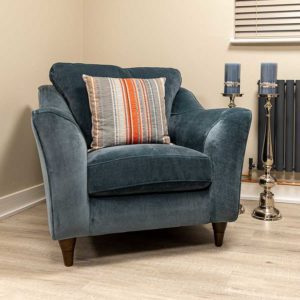 The Surrey comfy armchair upholstered in Warwick Manolo Hydro fabric with burnished Beech wood feet