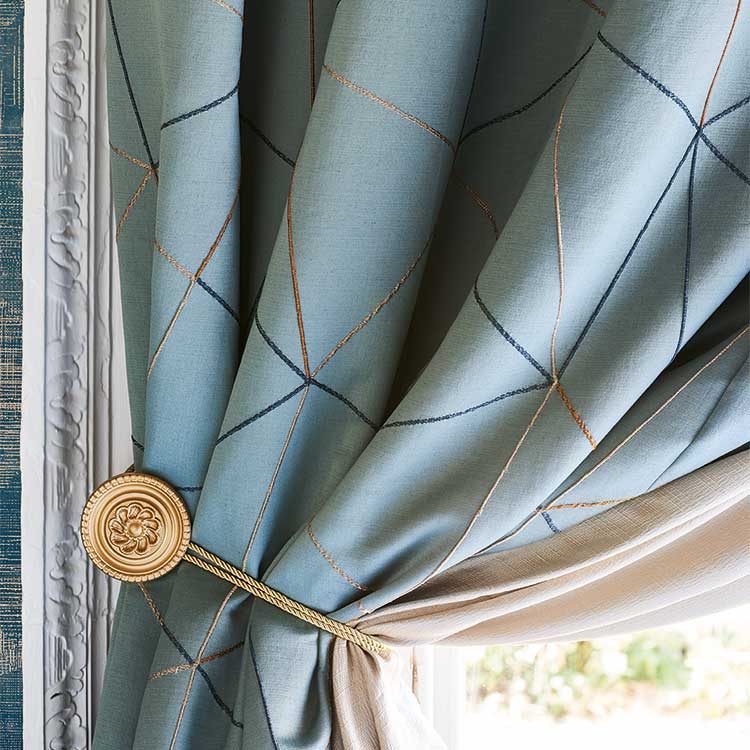 Luxury blue fabric used to make long drop curtains with tiebacks