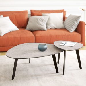 Pebble coffee table with stone effect ceramic top and matt black steel legs next to pebble side table