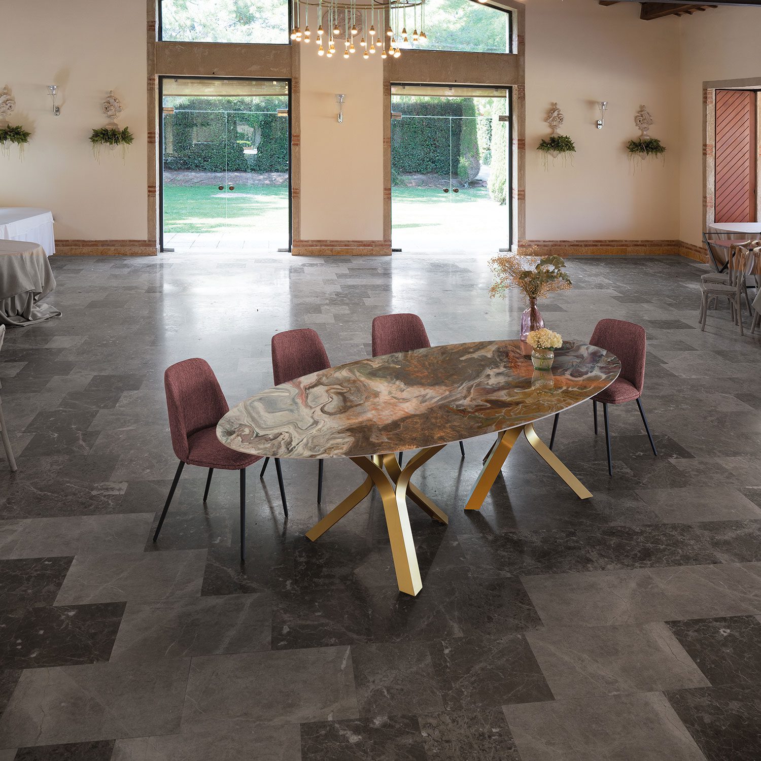 Oval bespoke dining table with Dekton sintered stone top and gold metal legs