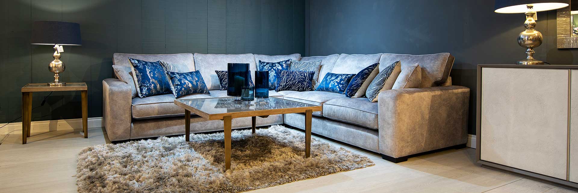 Large Lexington corner sofa with luxury silver upholstery and contrasting blue cushions