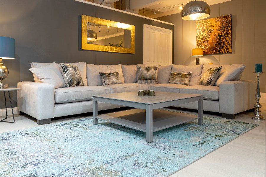This large white corner sofa fits the room perfectly and takes up less space than 2 sofas