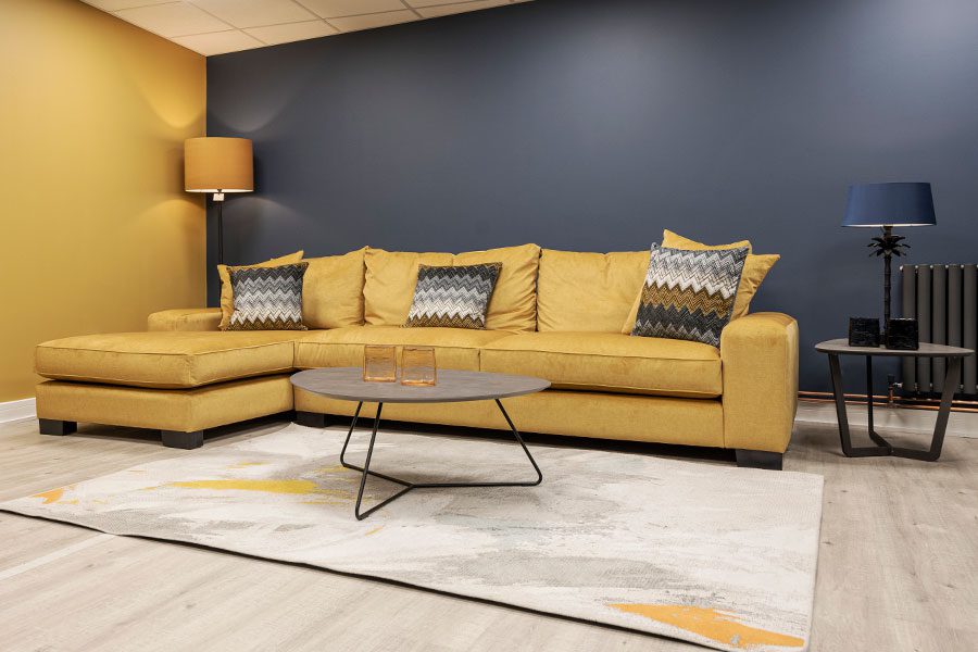 Large modern Washington chaise corner sofa in bright yellow material on display at New England Home Interiors in Horsham