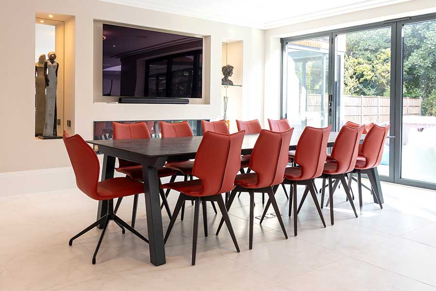 Bespoke Dekton 12 seat dining table with red leather dining chairs