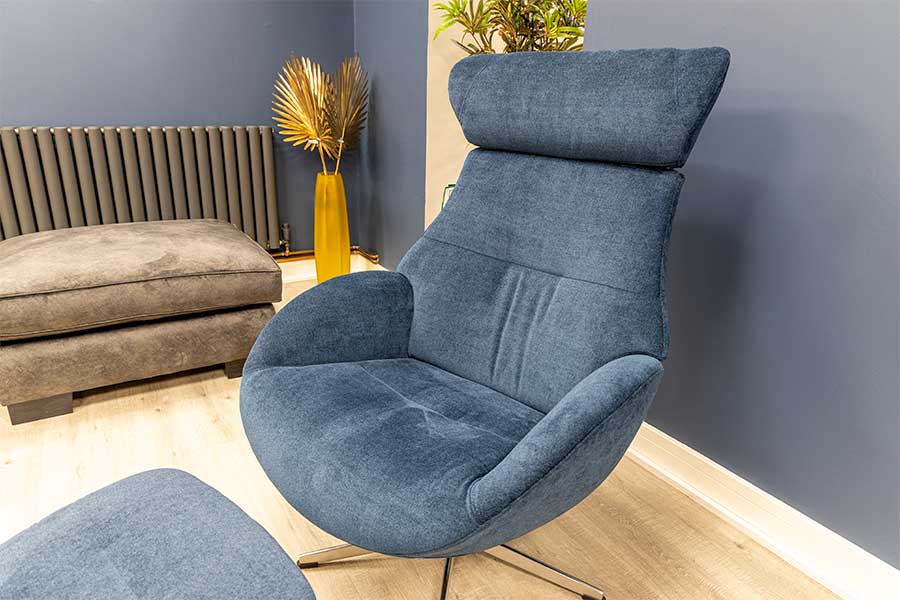 Globe reclining armchair upholstered in plush blue fabric 