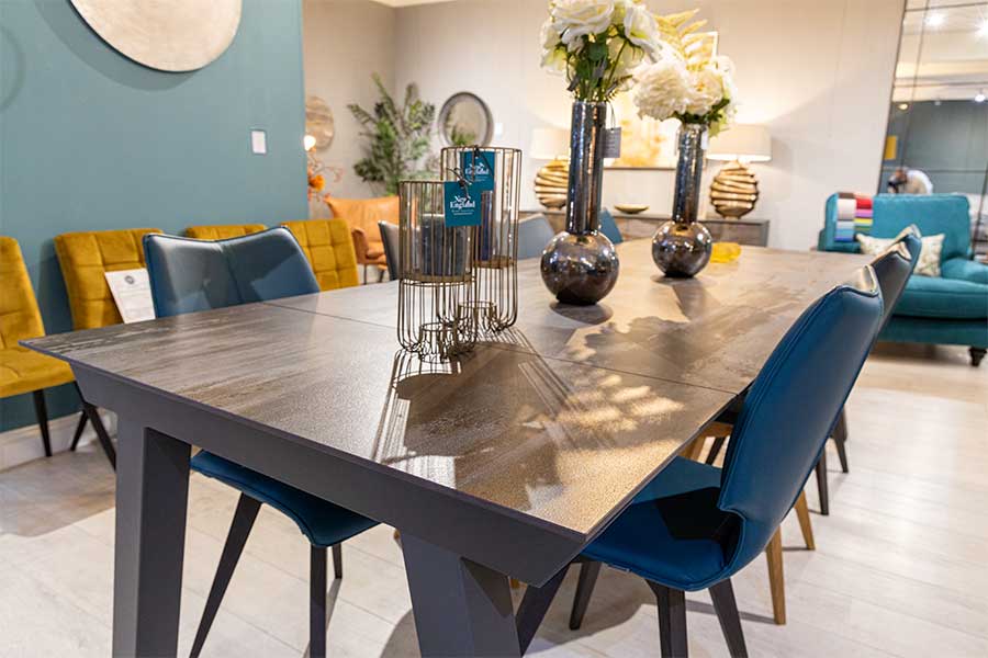 Large Dekton Trilium dining table with teal leather dining chairs