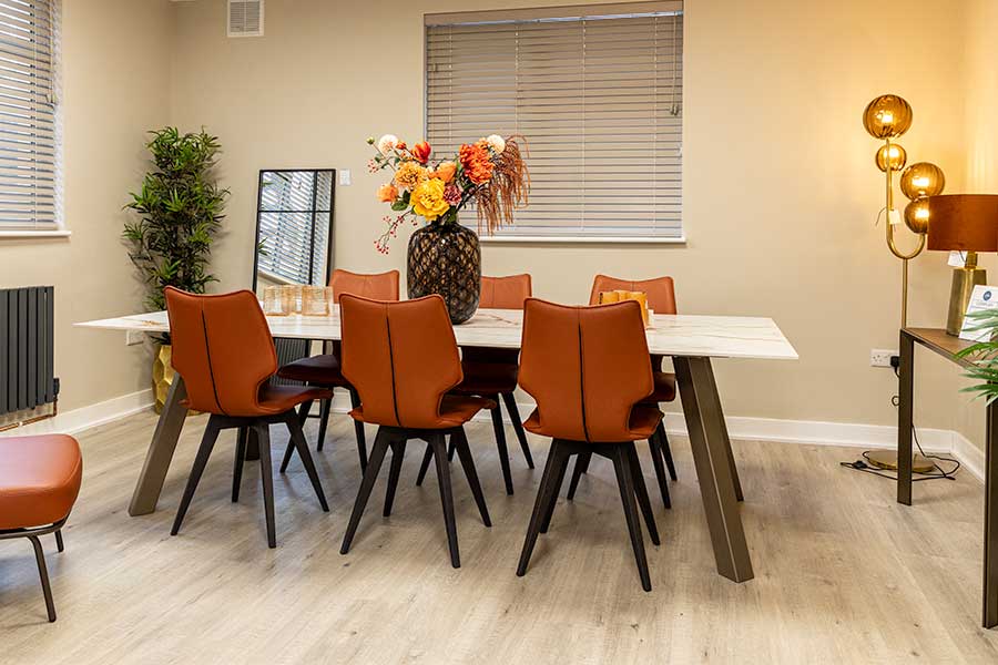 Lovely luxury red leather dining chairs around a white marble Dekton dining table