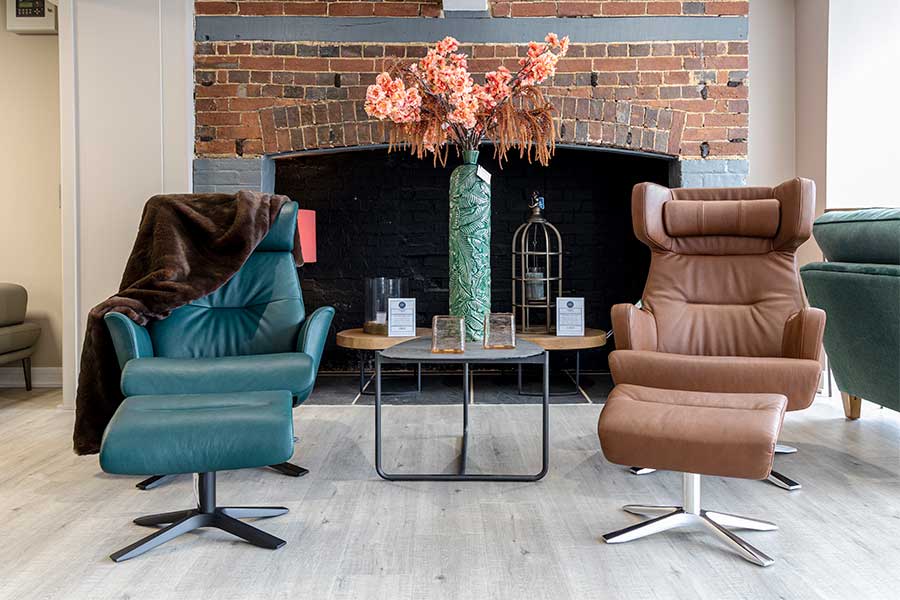 A patir of Conform luxury leather swivel recliner armchairs at New England Home Interiors