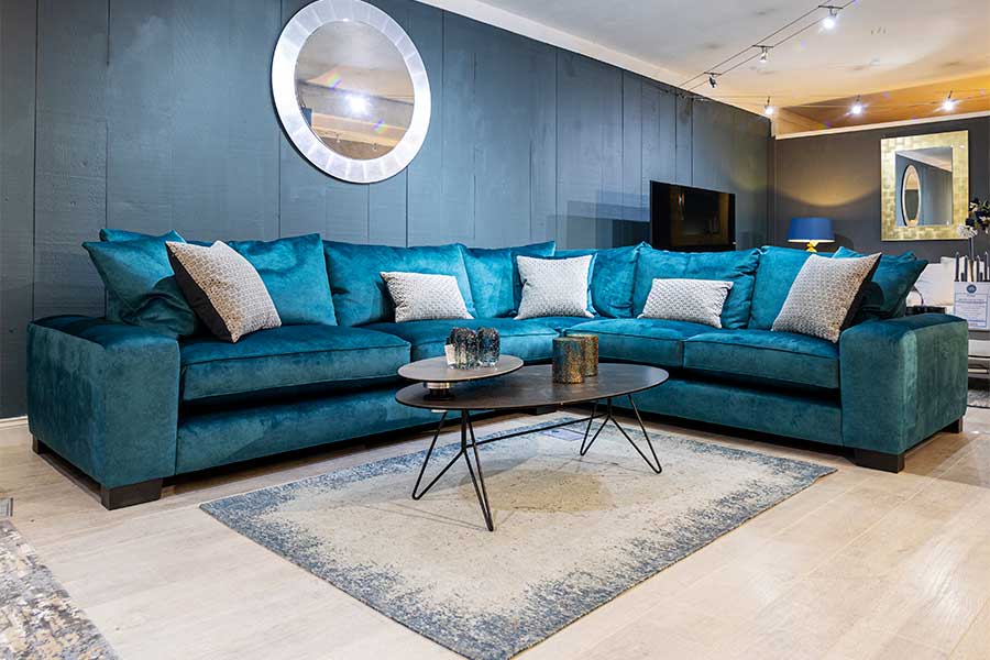 Extra large 8 seat Washington corner sofa upholstered in luxury teal easy clean velvet on display at New England Home Interiors